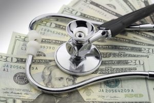 stethoscope on top of money to illustrate Medicaid Estate Recovery in New York