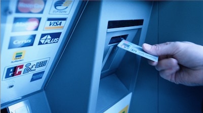 a person using a dead person's debit card at an ATM