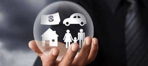a hand holding a bubble with a house, car, money, signifying what is an estate