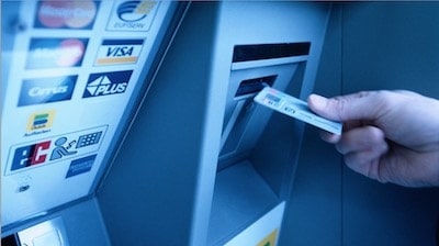 a person using dad's debit card with an atm